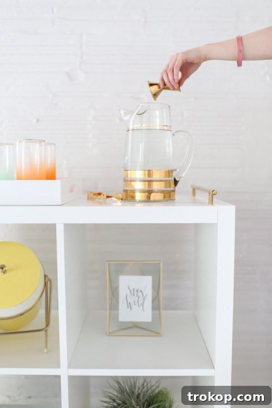 Materials for a DIY Ikea bar cart hack, including Ikea Kallax shelf, brass pulls, casters, and screws, by Sugar & Cloth.