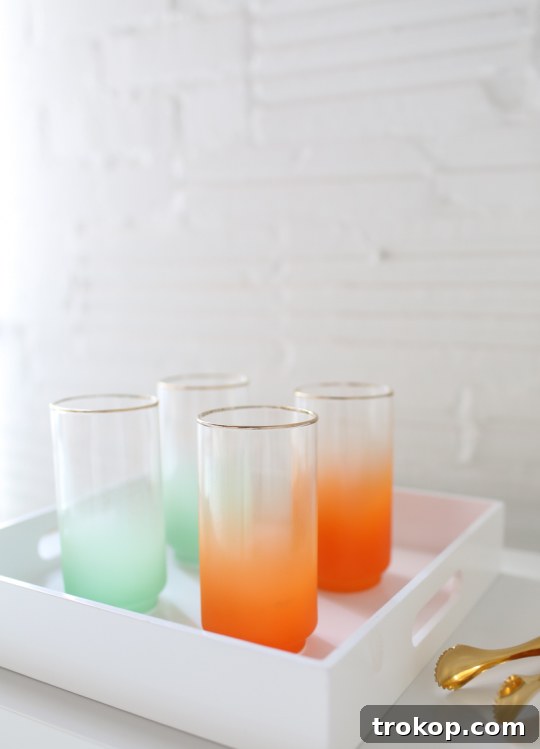 A beautifully decorated DIY Ikea bar cart hack featuring vintage Blendo glasses and a tilted ice bucket.