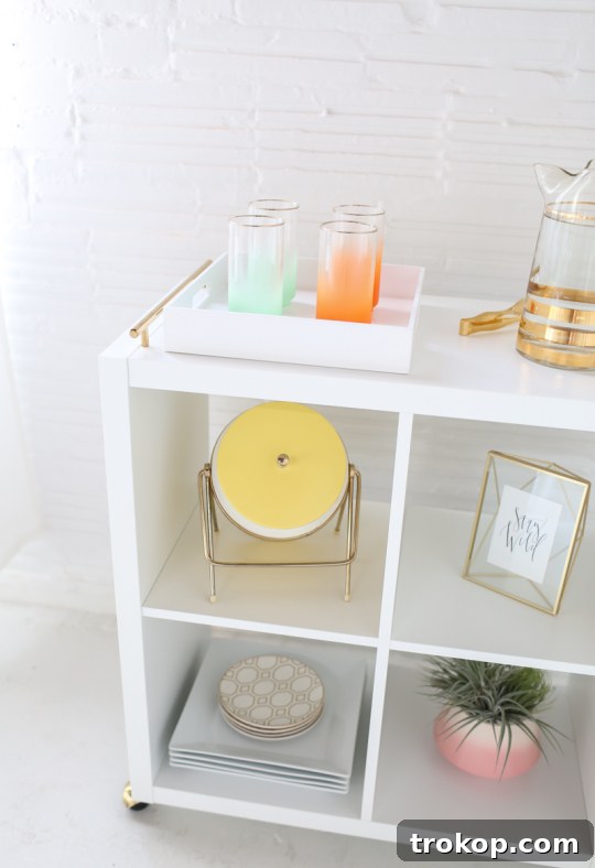 Close-up of bright brass hooded ball casters on the bottom of the DIY Ikea bar cart.