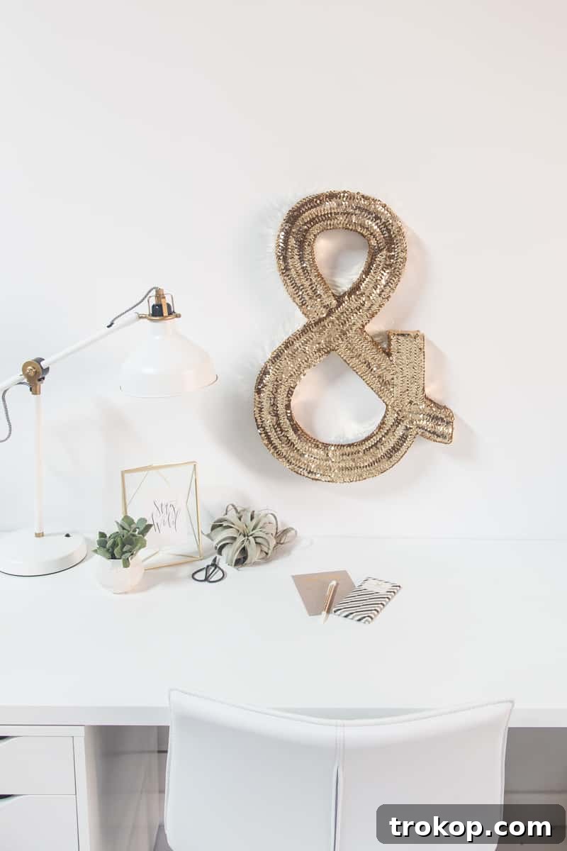 Stunning DIY jumbo sequin ampersand monogram art piece for a stylish creative studio or home office, catching the light beautifully.