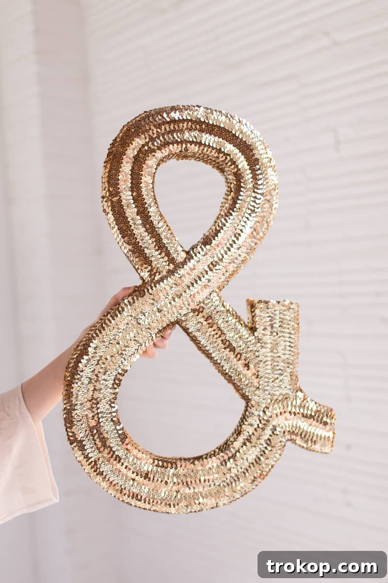 Finished DIY jumbo sequin monogram prominently displayed in a modern and creatively designed studio setting, reflecting the vibrant brand identity.