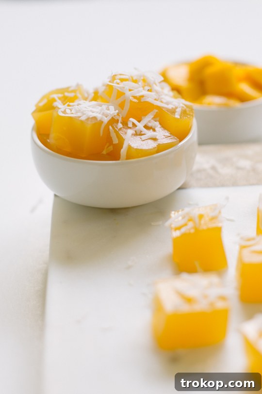 Close-up of mango jello bites with juicy mango flavor and shredded coconut