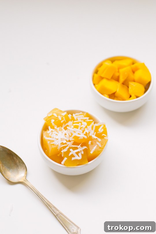 Solid mango jello in a container, ready to be cut into bites