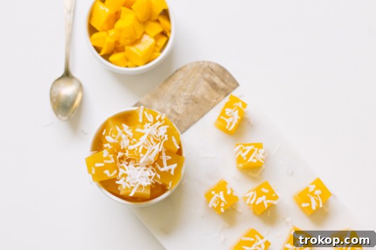 Tasty dessert mango jello bites ready to be eaten, garnished with coconut