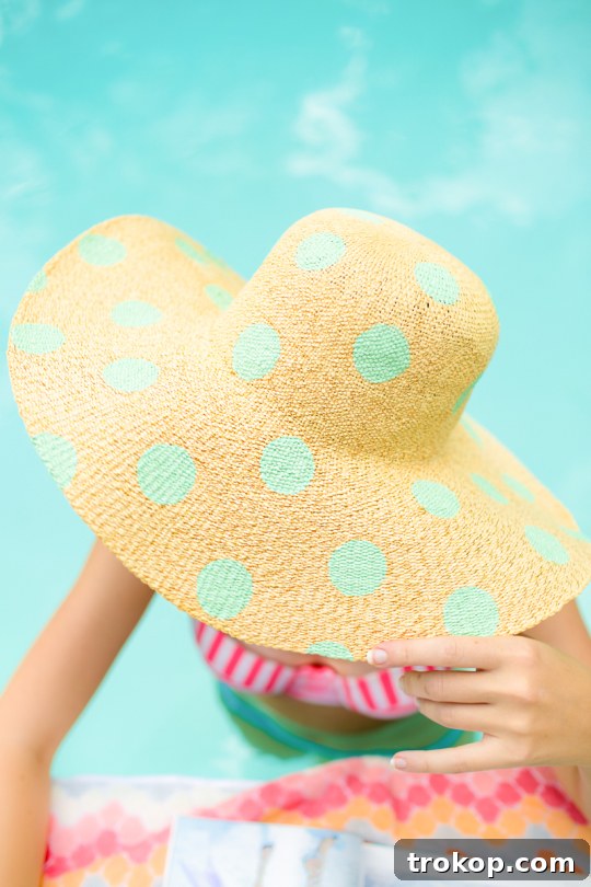 Stylish DIY Polka Dot Floppy Hat 3 A stylish woman confidently wearing a pink and white polka dot floppy hat indoors, emphasizing comfort and personal style.