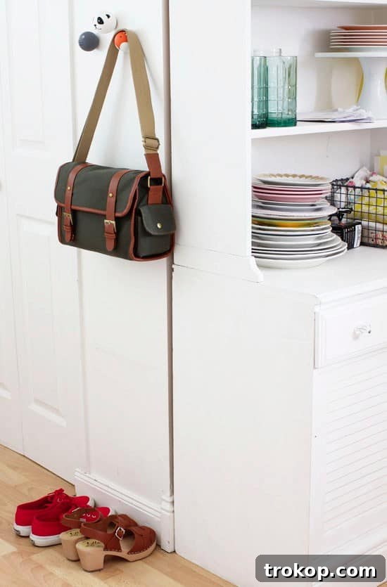 A charming entryway featuring DIY animal knobs as hooks