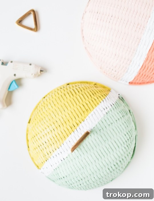 Make Vibrant Colorblock Food Domes 6 A person meticulously painting a woven basket to create a colorblock food dome