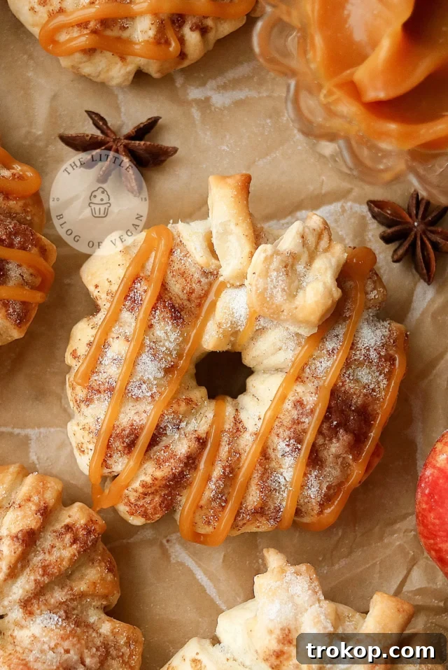Soft, spiced vegan caramel apple donuts drizzled with dairy-free caramel, a quick 30-minute fall dessert made with puff pastry.