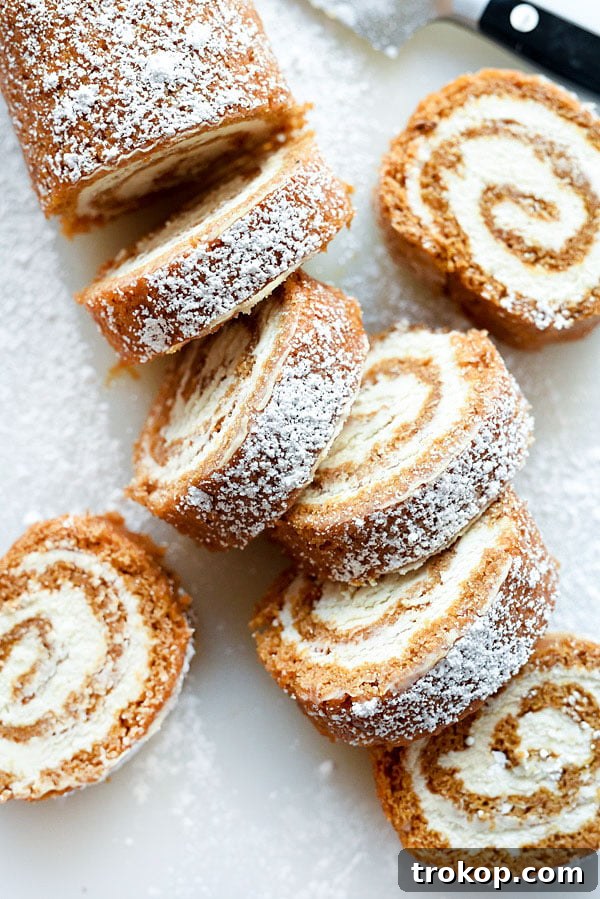 Classic pumpkin rolls featuring soft, spiced pumpkin cake rolled with a creamy, sweet filling, showcasing a beautiful swirl.
