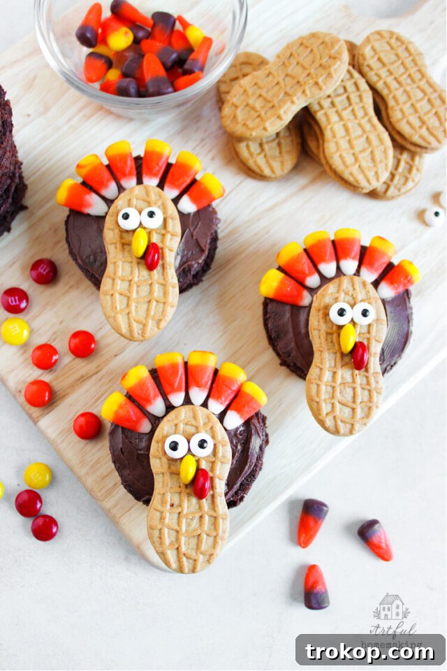 Festive Thanksgiving turkey brownies decorated with Nutter Butter cookies, M&M's, candy eyes, and candy corn.