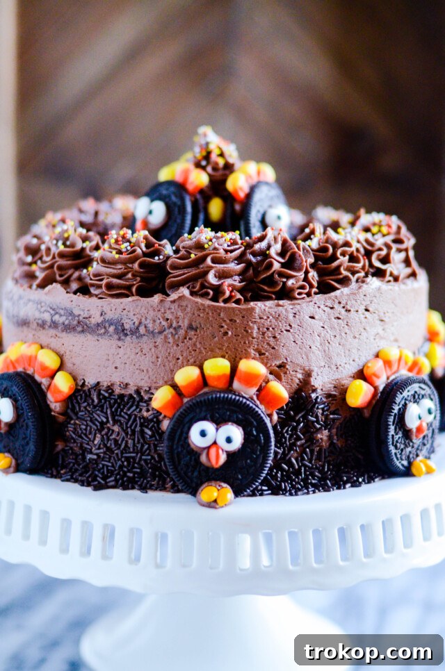 Rich chocolate cake layers with cream cheese frosting and chocolate buttercream, decorated with Oreos for a festive Thanksgiving Oreo cake.