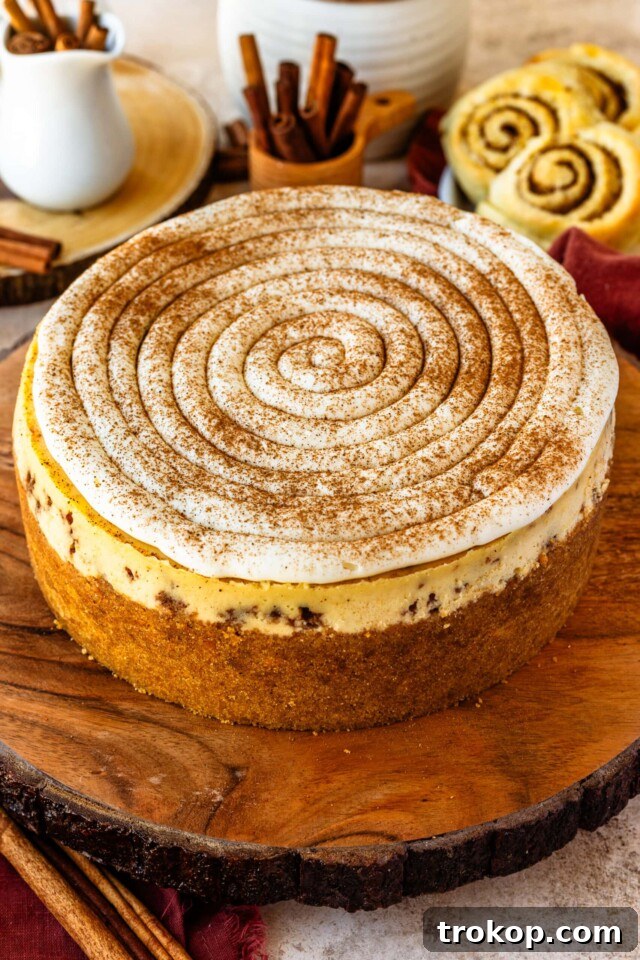 Decadent cinnamon roll cheesecake combining creamy cheesecake with a swirled cinnamon filling, perfect for Thanksgiving dessert.