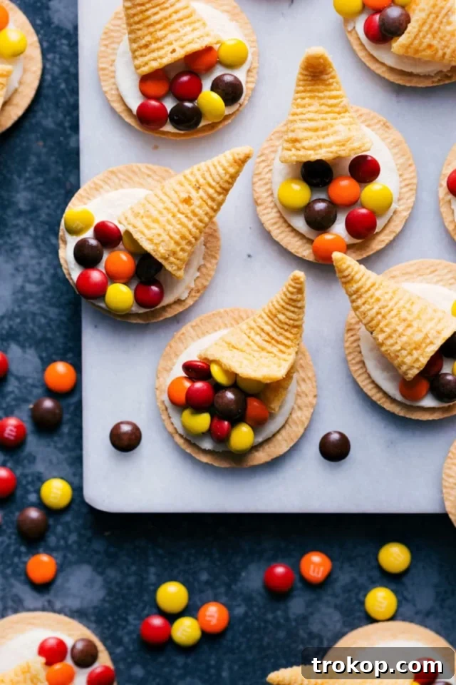 Easy 3-ingredient Thanksgiving cornucopia cookies made with Golden Oreos, Bugles, and M&M's, a quick and festive treat.