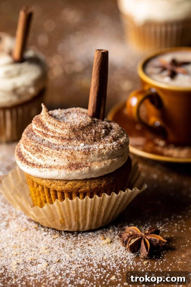 Vanilla chai pumpkin latte cupcakes with creamy cinnamon brown sugar frosting and chai brown sugar sprinkle, embodying fall flavors.