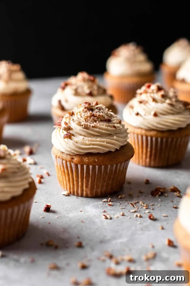Pecan pie cupcakes: tender brown sugar cake with rich pecan pie filling and sweet buttercream frosting, delivering classic flavors.