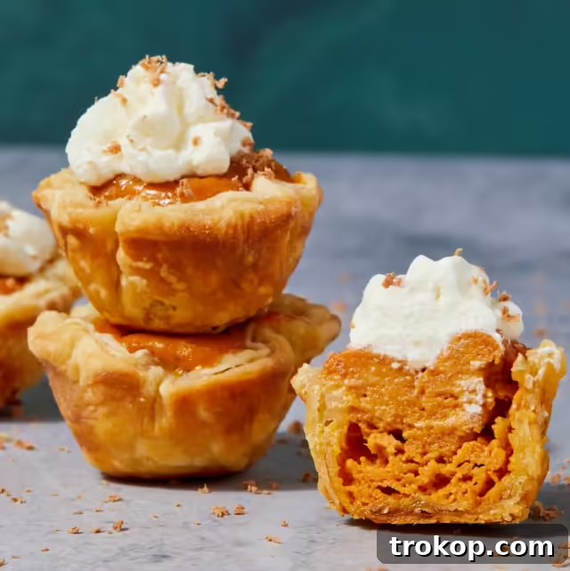 Bite-sized mini pumpkin pies offering warm, spiced pumpkin flavor in cute individual servings, perfect for fall.