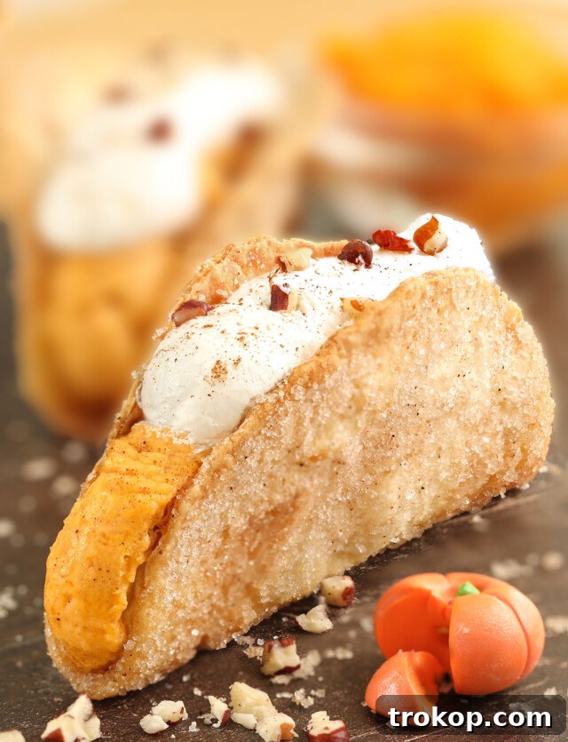 Pumpkin Pie Tacos with creamy pumpkin spice filling and whipped cream, a unique and handheld Thanksgiving dessert.