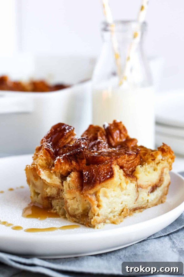 Classic croissant bread pudding soaked in rich custard and baked to golden perfection, a comforting Thanksgiving dessert.