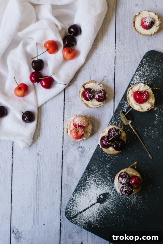 Perfect Bite-Sized Cherry Tarts 2 Mini cherry tarts with mascarpone filling and fresh cherries on a white platter