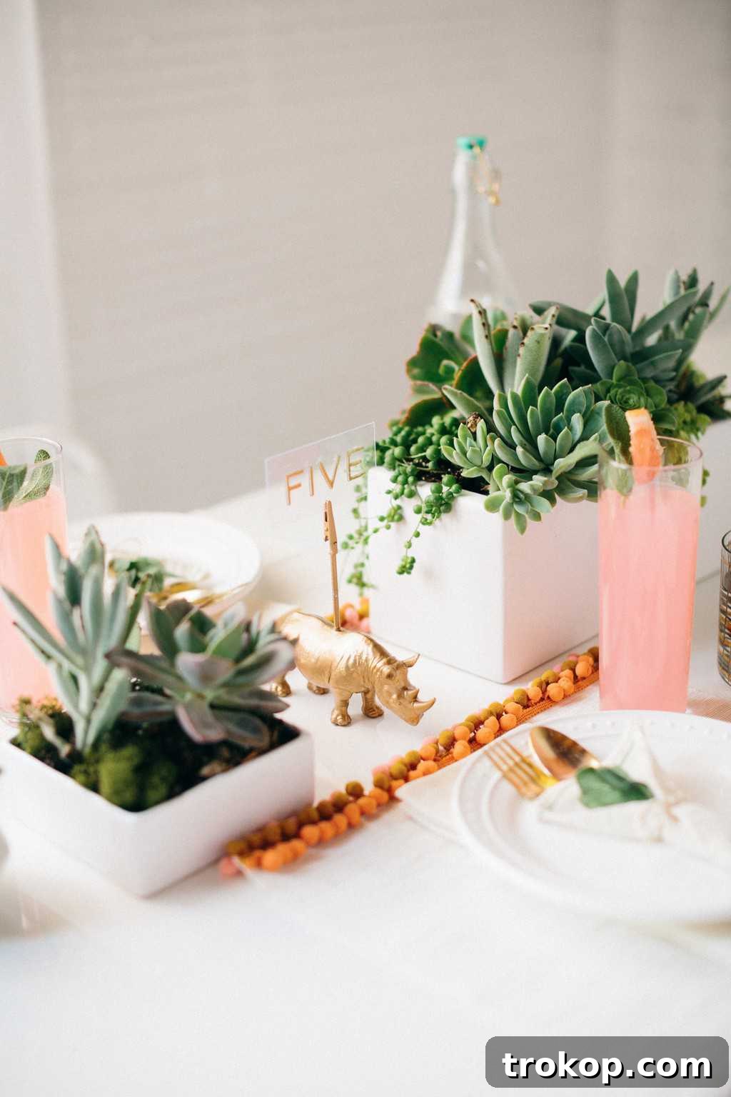Stunning succulent centerpiece in a geometric vase, anchoring a beautiful summer table setting