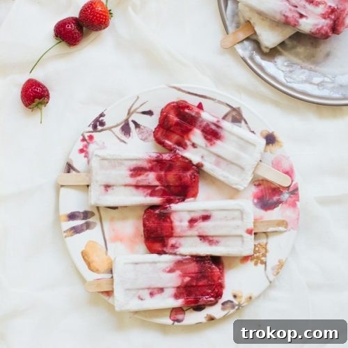 photo of marbled strawberry coconut popsicle recipe | sugarandcloth.com