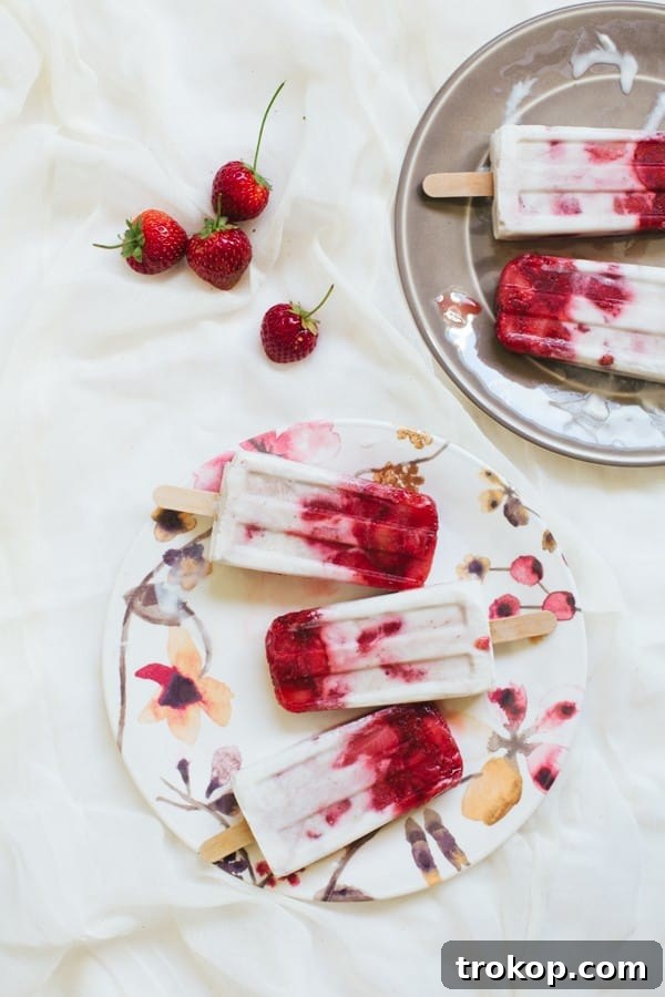 Strawberry Coconut Swirl Pops 3 marbled strawberry coconut popsicle recipe | sugarandcloth.com