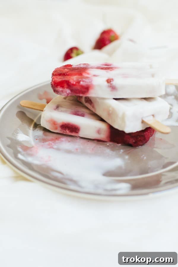 Strawberry Coconut Swirl Pops 5 marbled strawberry coconut popsicle recipe | sugarandcloth.com