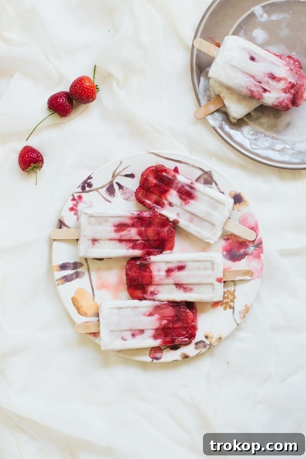 Strawberry Coconut Swirl Pops 10 marbled strawberry coconut popsicle recipe | sugarandcloth.com