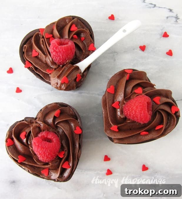34 Irresistible Valentine's Day Treats 11 Individual mini desserts: rich chocolate mousse nestled in delicate, heart-shaped chocolate cups, an elegant Valentine's Day treat.