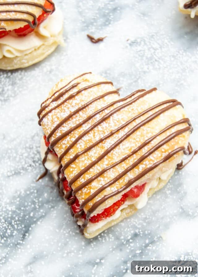 34 Irresistible Valentine's Day Treats 32 Delicate heart-shaped puff pastry filled with fresh whipped cream, juicy sliced strawberries, and a drizzle of Nutella, balancing crisp, creamy, and chocolatey flavors.