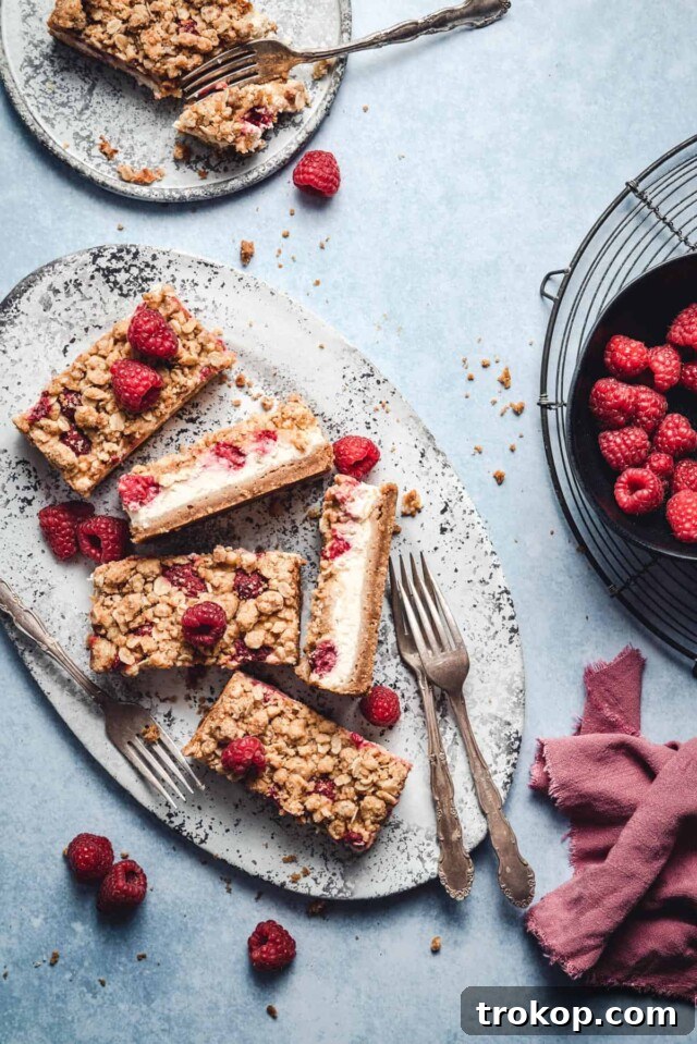 34 Irresistible Valentine's Day Treats 34 Delicious raspberry lemon cheesecake bars featuring a crunchy graham cracker crust, creamy lemon cheesecake, tangy fresh raspberries, and a buttery streusel topping for a delightful blend of textures and flavors.