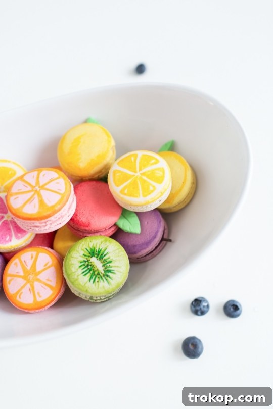 An array of fruit macarons, showcasing various designs.