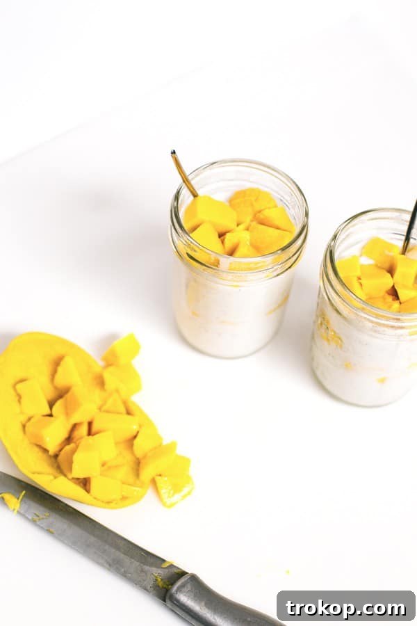 Tropical Mango Coconut Delight 3 Close-up of Mango Coconut Pudding in a glass jar, showing layers