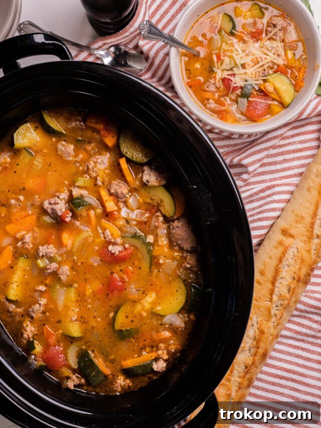 Hearty slow cooker Italian summer soup with fresh vegetables and sausage