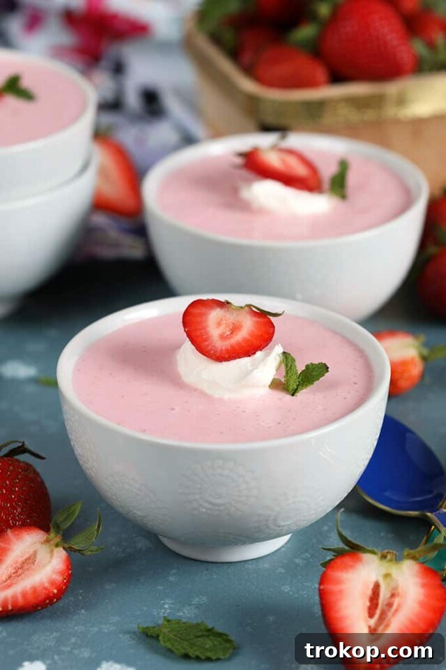Sweet and creamy chilled strawberry soup in a glass bowl