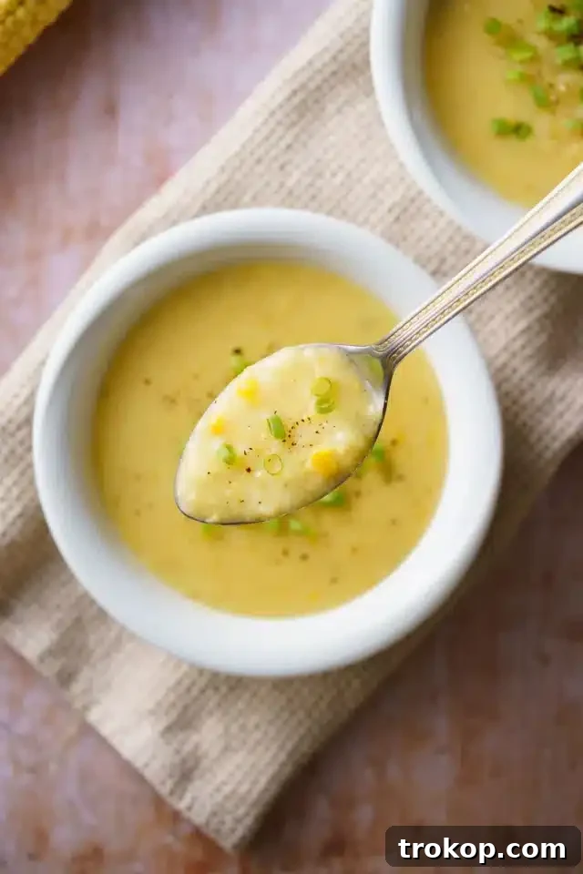 Creamy vegan sweet corn soup in a white bowl