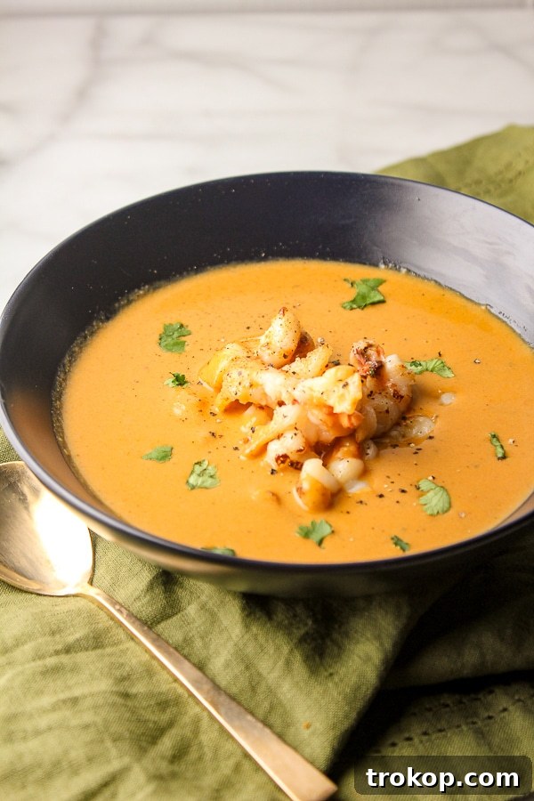 Luxurious classic lobster bisque, garnished with fresh herbs