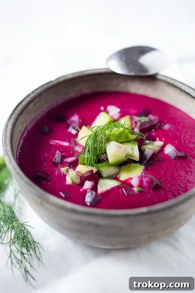 Vibrant vegan and gluten-free beet gazpacho with fresh toppings