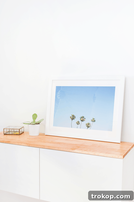 A stylish room showcasing the DIY IKEA hack floating credenza and a geometric accent wall.