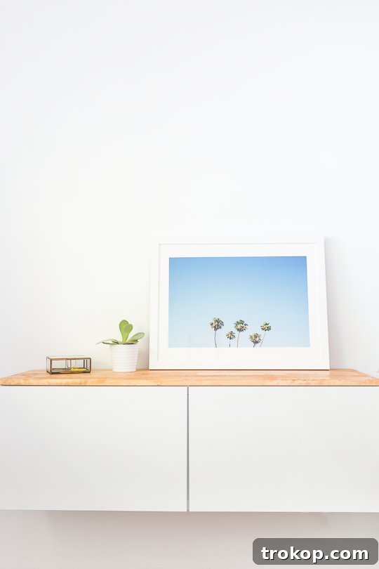 Close-up of the stylish DIY IKEA hack floating credenza with decorative items, highlighting the wood grain.