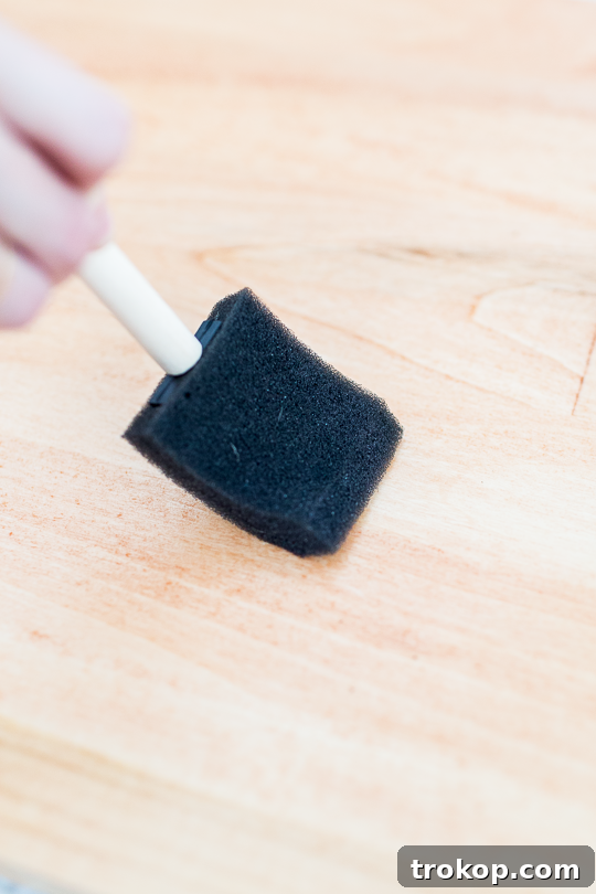 Step-by-step image of placing the custom wood panel on top of the mounted IKEA Besta unit.