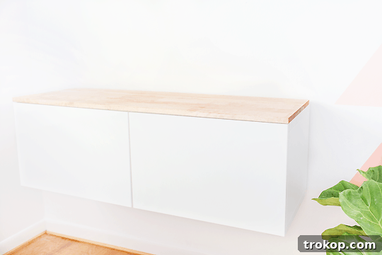 Step-by-step image of attaching the finished wood top to the IKEA Besta unit using contact cement.