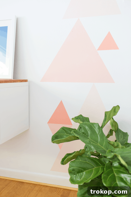 Staggered geometric wall design with coral, mist, and apricot shades
