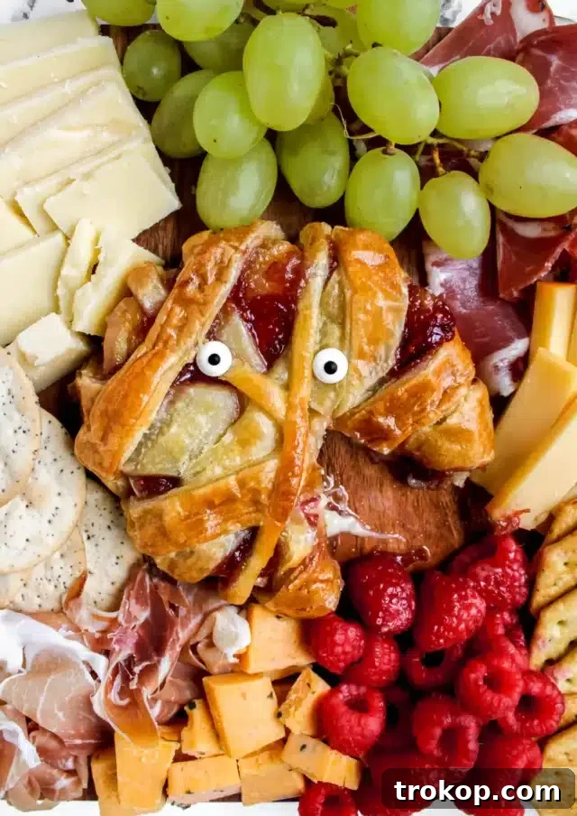 Ghoulishly Good Halloween Party Bites 13 Mummy Baked Brie Recipe for Halloween food ideas