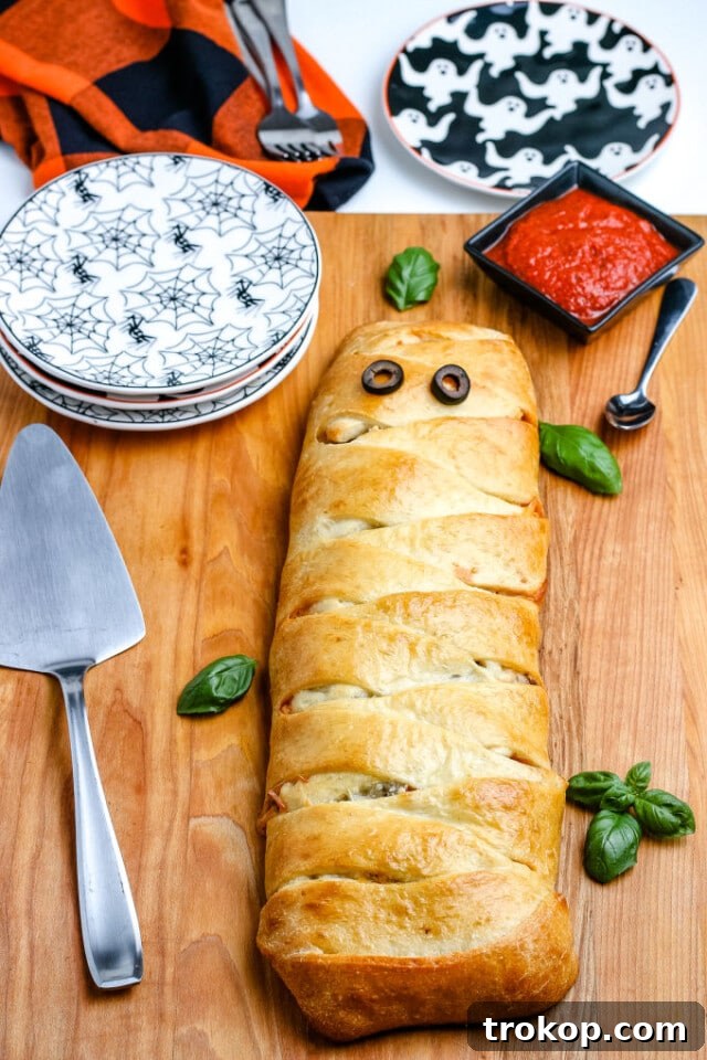 Ghoulishly Good Halloween Party Bites 45 Mummy Pizza Calzone Recipe for Halloween food ideas