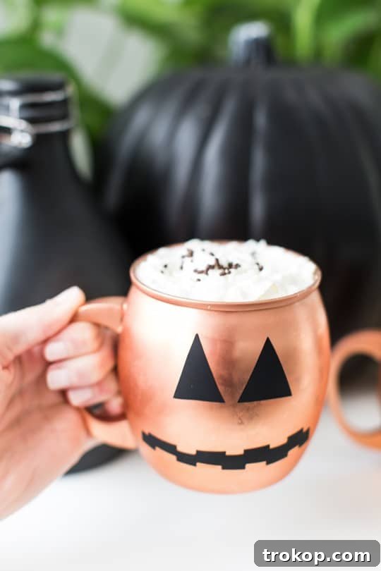 Spookify Your Glasses with Pumpkin Decals 3 Copper mugs with DIY pumpkin face decals for Halloween