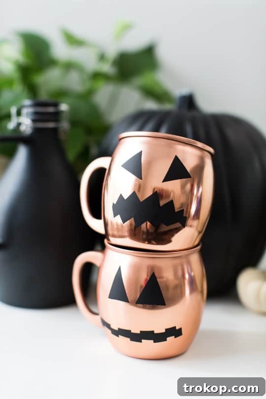 Spookify Your Glasses with Pumpkin Decals 8 Copper mugs with pumpkin decals being washed gently