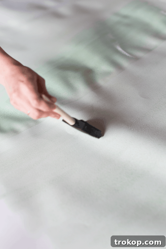 Craft Your Own Watercolor Wall Decor 6 Application of the lightest watercolor shade on large paper, leaving a white border.