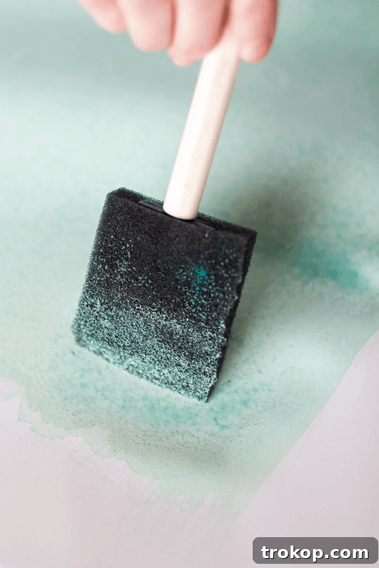 Craft Your Own Watercolor Wall Decor 7 Applying the medium watercolor shade, blending carefully to avoid puddles.