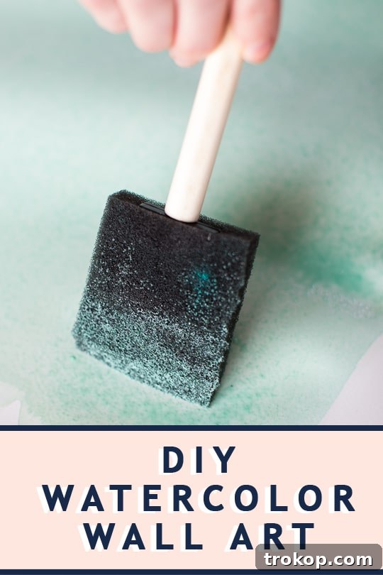 Craft Your Own Watercolor Wall Decor 10 Ashley Rose of Sugar & Cloth showcasing her DIY watercolor wall art, perfect for modern home decor.